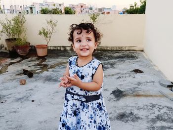 Portrait of cute girl standing outdoors