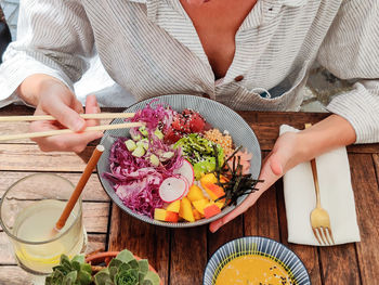 High angle view of woman preparing food on table