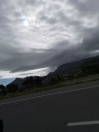 Road by landscape against sky