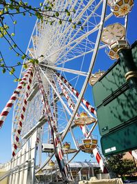 Low angle view of ferris wheel against clear sky