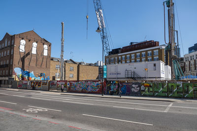 Vehicles on road against buildings in city