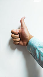 Midsection of man making face against white background