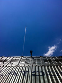 Low angle view of modern building against blue sky