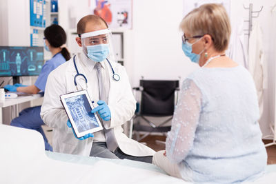 Female doctor examining patient in clinic