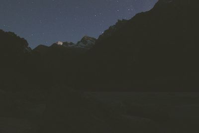 Scenic view of mountains against sky at night