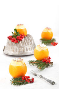 Close-up of fruits on table against white background