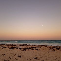 Scenic view of beach against sky during sunset