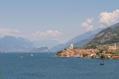 Scenic view of sea and mountains against sky