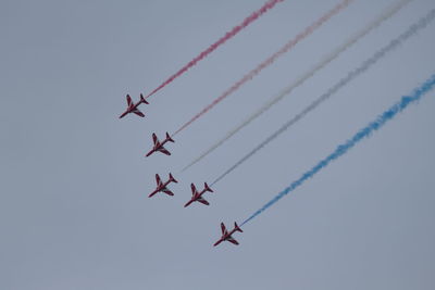 Low angle view of airshow against sky