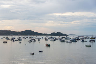 Sailboats in sea against sky