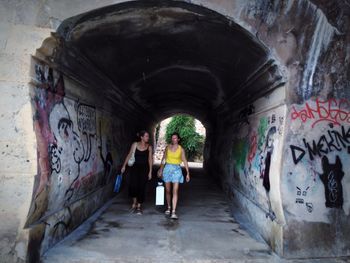 Rear view of people in tunnel