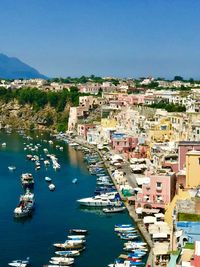 High angle view of townscape by sea against clear sky