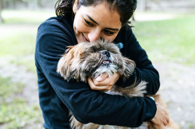Close-up of woman embracing dog