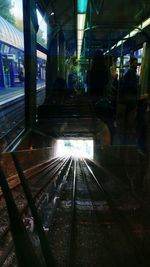 Train at railroad station platform at night