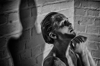 Woman covered with powder by wall