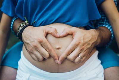 Midsection of couple holding hands