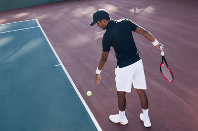Rear view of man playing tennis