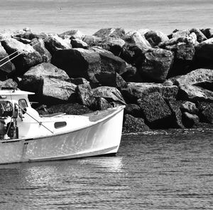 High angle view of rocks and boat on sea shore