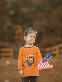 Cute boy holding small standing outdoors