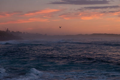 Scenic view of sea against orange sky