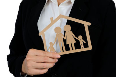 Midsection of woman holding hands against black background