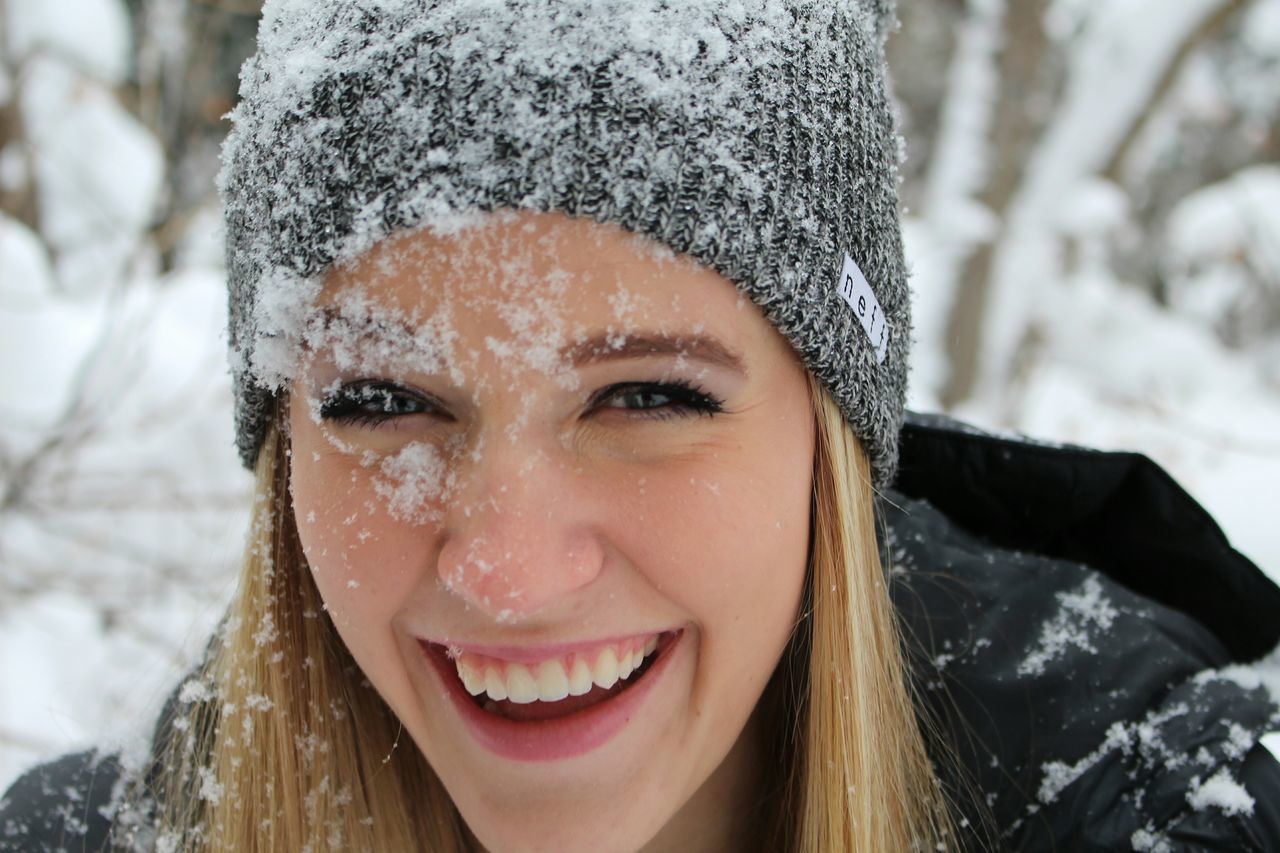 headshot, portrait, looking at camera, front view, focus on foreground, person, close-up, young adult, lifestyles, smiling, leisure activity, human face, winter, cold temperature, day, head and shoulders, snow, outdoors