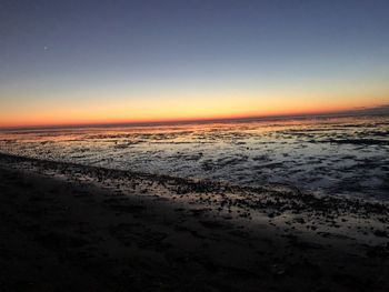 Scenic view of sea against clear sky during sunset