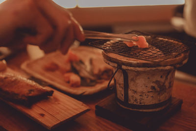 Close-up of person preparing food on cutting board