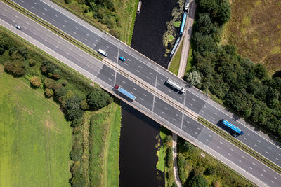 Aerial view directly above a busy uk motorway over a river or canal bridge in the countryside