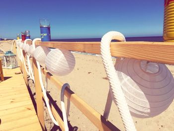 Chairs on beach against clear sky