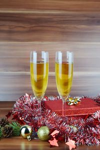 Close-up of champagne flute with christmas decorations on table