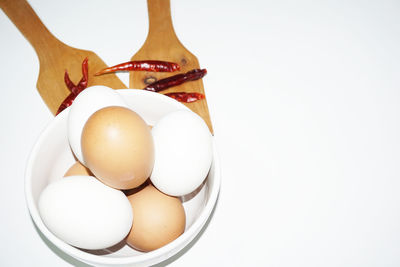 Close-up of eggs against white background