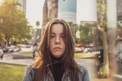 Portrait of young woman in city