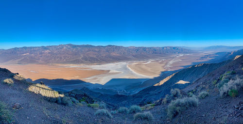 Scenic view of mountains against clear blue sky