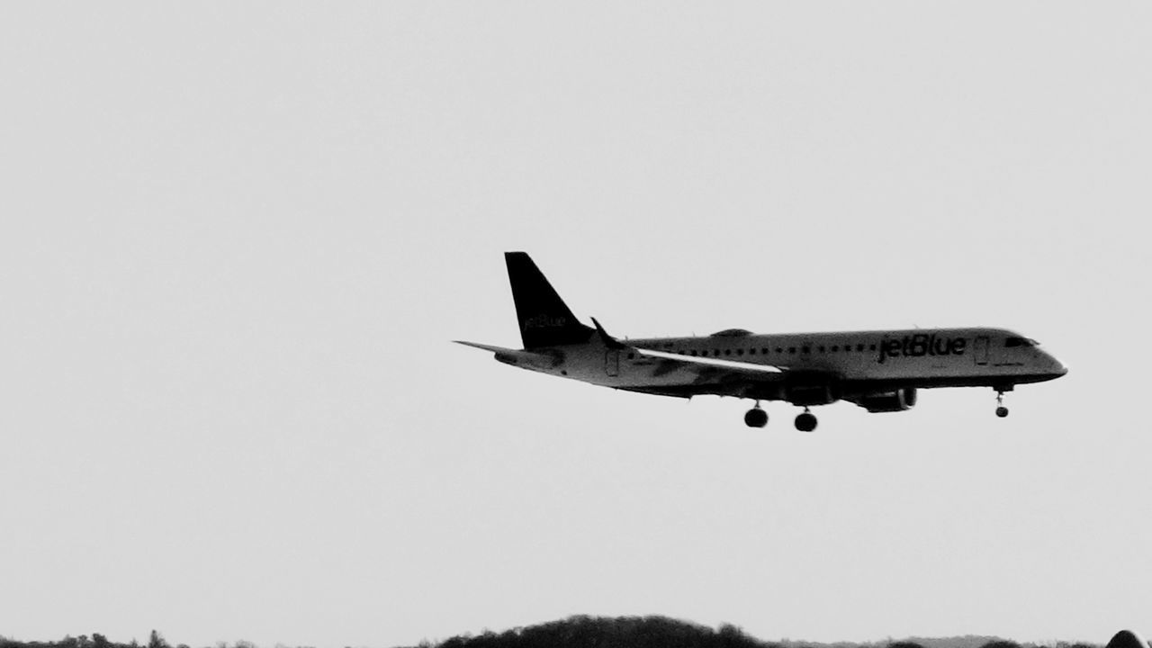 AIRPLANE FLYING AGAINST CLEAR SKY