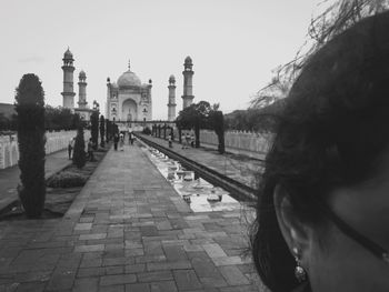 Group of people in temple against sky