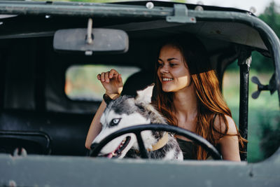 Portrait of young woman sitting in car