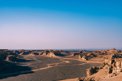 Panoramic view of arid landscape against clear sky