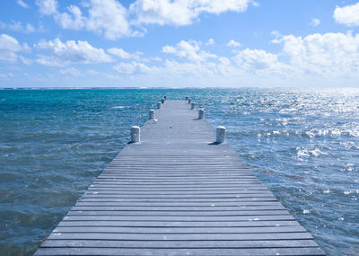 Pier over sea against sky