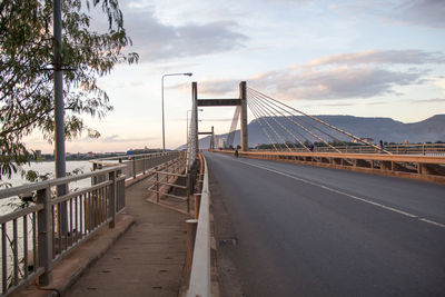 View of suspension bridge against cloudy sky