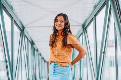 Portrait of woman standing on footbridge