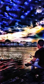 Woman sitting on boat against sky during sunset