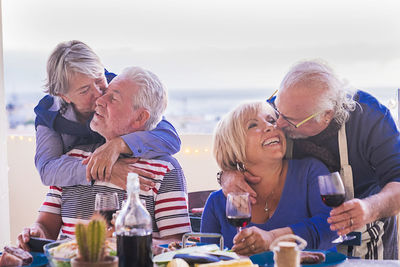 Senior couple in balcony during social gathering