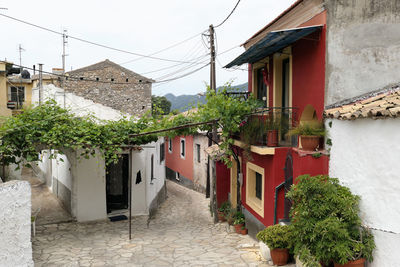 Footpath amidst buildings against sky