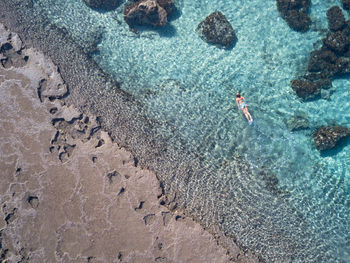 High angle view of woman swimming in sea