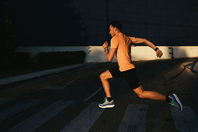 Woman running on road in city