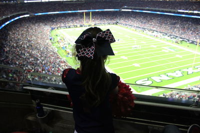 Woman standing on soccer field at night