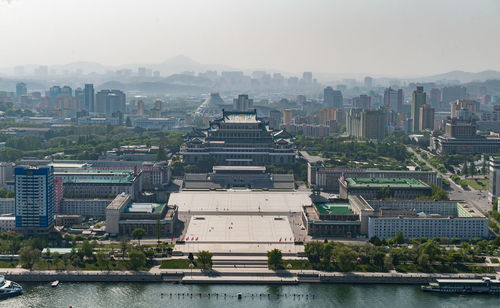 Buildings in city against clear sky