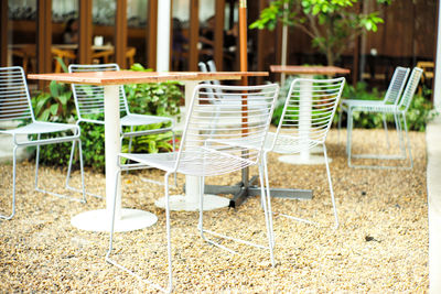 Vacancy outdoor furniture in the garden. steel chairs and wooden table in the park
