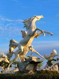 Low angle view of statue against blue sky